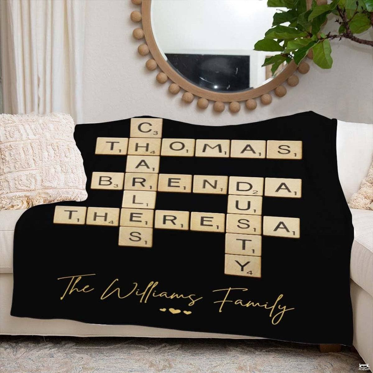 Lifestyle bedroom view showing the black wooden letter tiles throw blanket styled across a bed.
