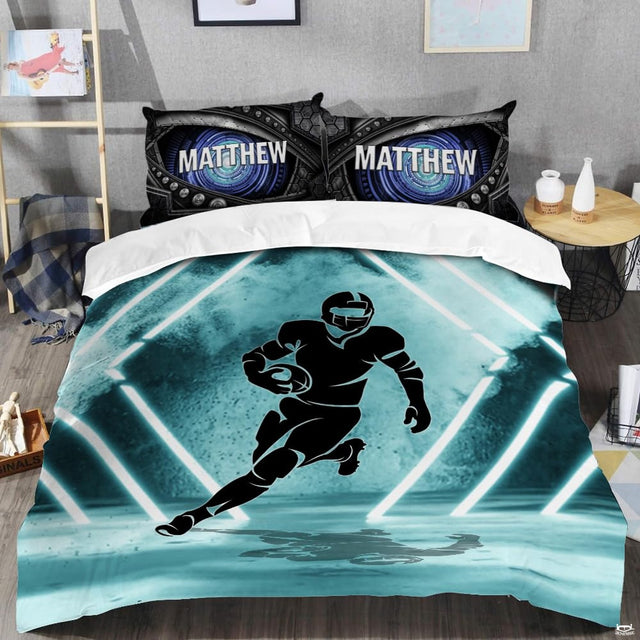 Close-up perspective of football bedding detailing aqua yard lines, crisp white lacing, and collegiate typography