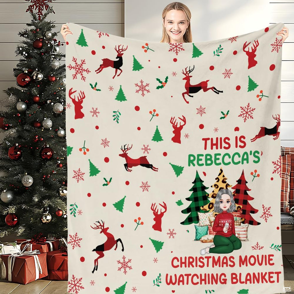 Front view of reindeer Christmas movie throw blanket held upright displaying leaping plaid stags.