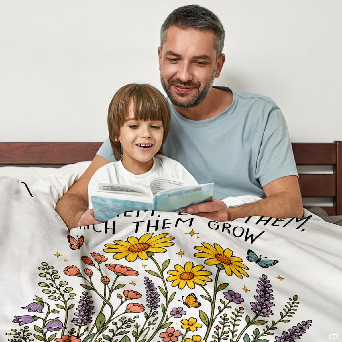 Close up of teacher wildflower throw blanket highlighting yellow daisies, lavender spires, and typography