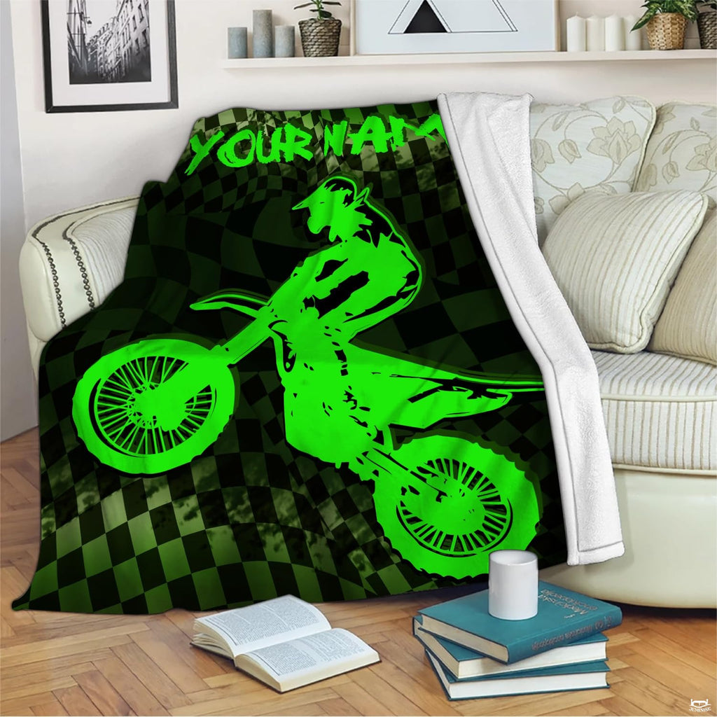 Neon green motocross throw blanket view 2 highlighting dirt bike jumper, checkered flag, and green background