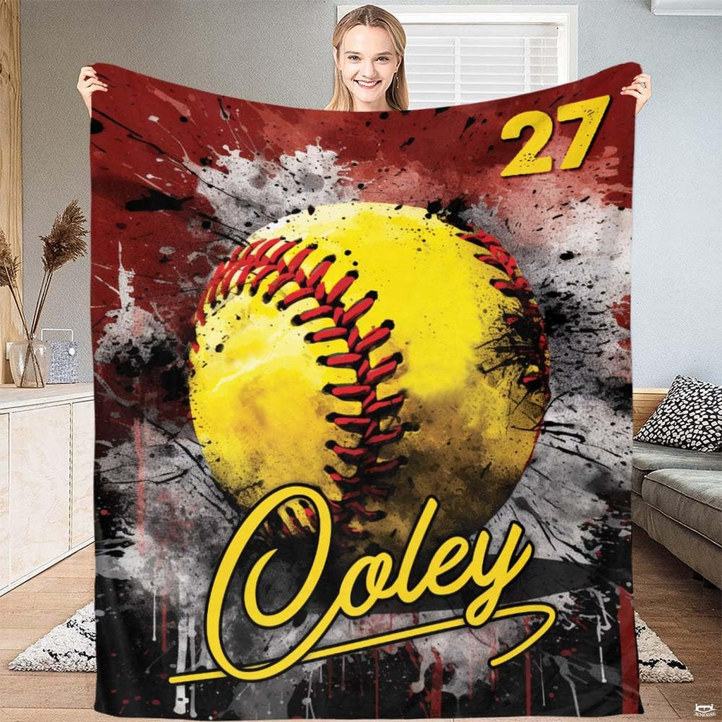 Woman holding up full size athletic softball blanket in living room