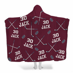 Ice hockey bedding set pattern showing crossed sticks and pucks on maroon burgundy background.