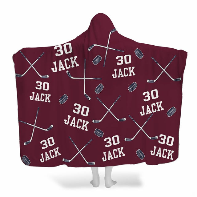Ice hockey bedding set pattern showing crossed sticks and pucks on maroon burgundy background.
