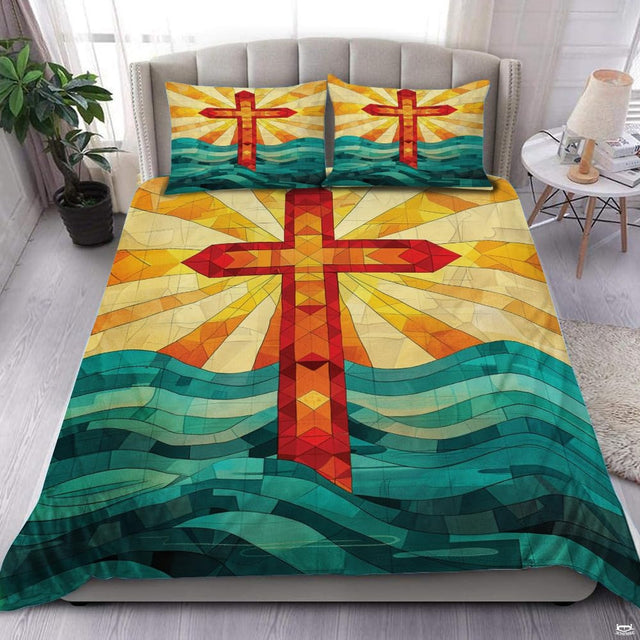 Stained glass cross bedding set with radiant sunburst and turquoise ocean waves.