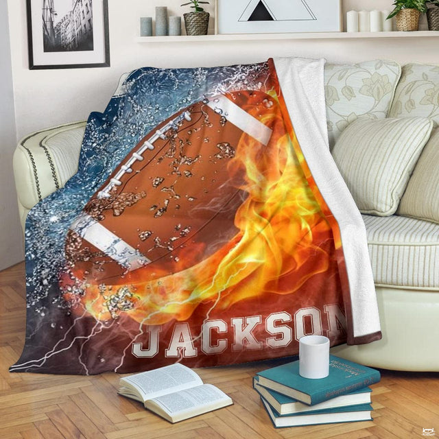 Close view of football with water droplets and blazing fire on blanket
