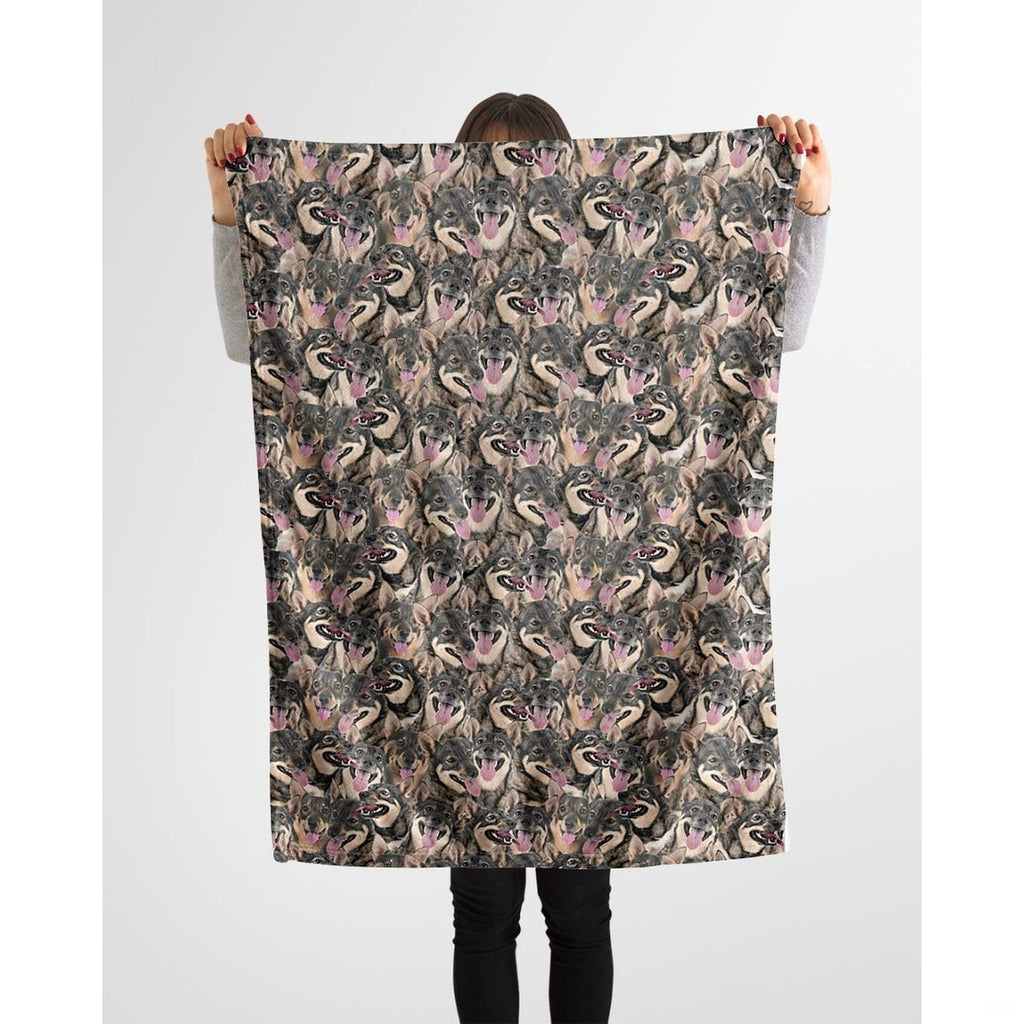 Swedish Vallhund collage blanket styled across a couch in a bright living room.