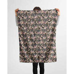 Swedish Vallhund collage blanket styled across a couch in a bright living room.