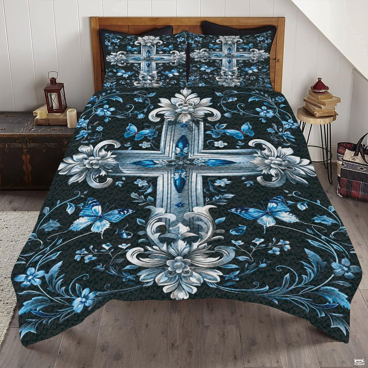Blue floral cross bedding set featuring an ornate silver and sapphire emblem with butterflies on dark backdrop.
