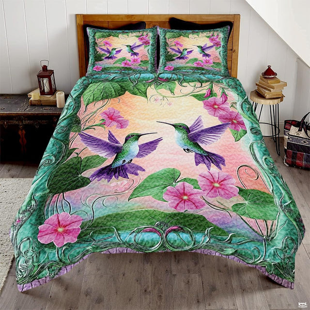 Two green hummingbirds with lavender wings, pink flowers, and teal scroll border