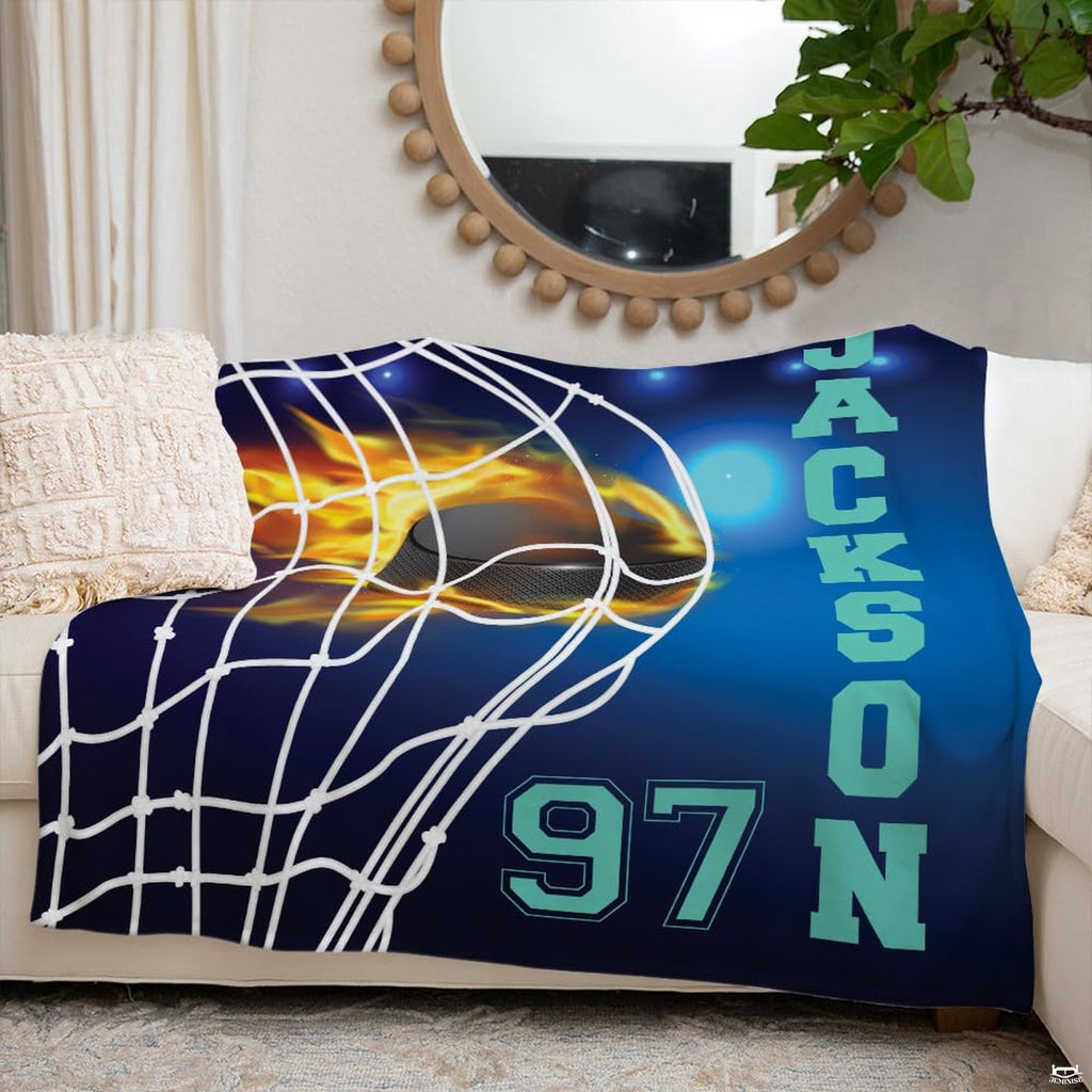 Flaming hockey puck sports blanket styled neatly across an ivory living room couch.