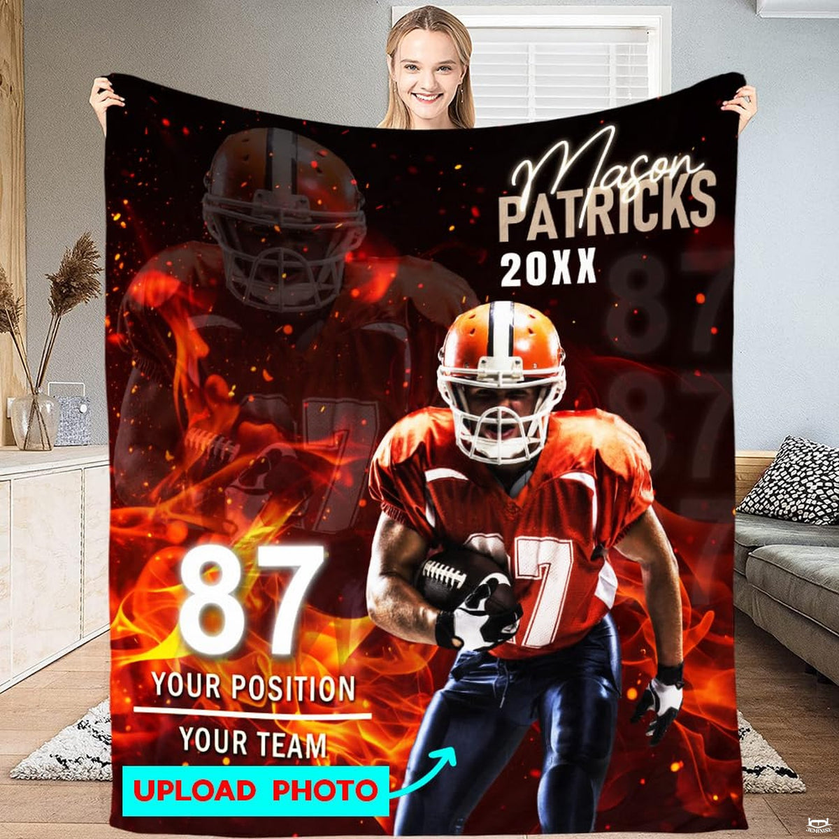 Woman displaying fiery football player graphic throw blanket with photo preview guide on football turf.