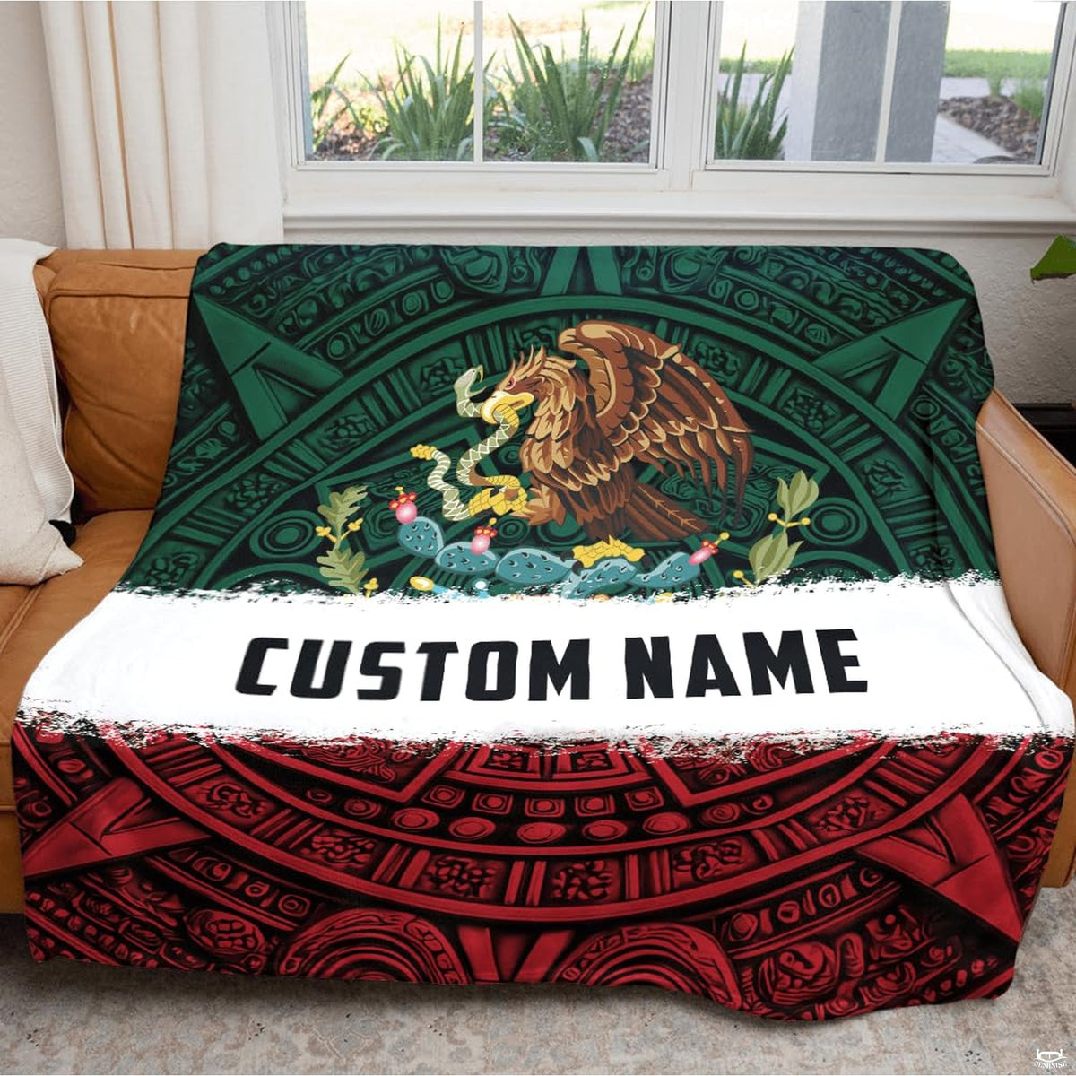 Close-up detail of Mexican eagle emblem and Aztec calendar stone carving on throw blanket