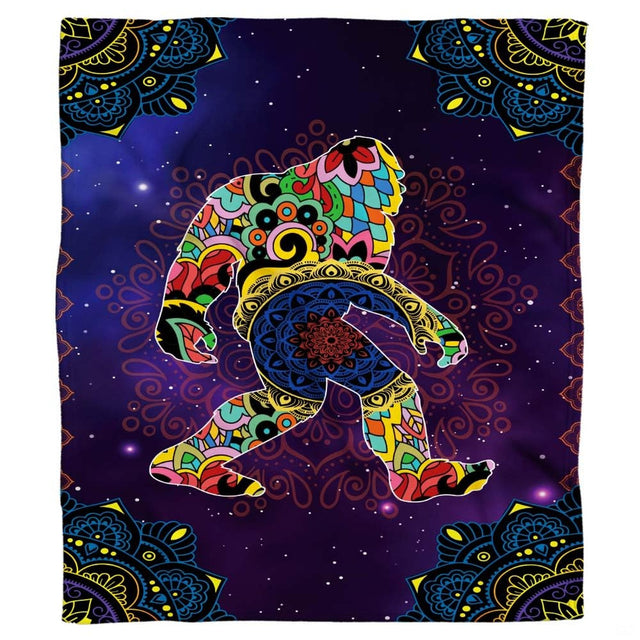 Flat product view showing the colorful floral mandala Bigfoot blanket on a purple starry sky.