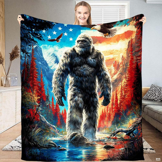 Bigfoot Sasquatch in mountain river with patriotic flag sky and bald eagles graphic print on Blanket.