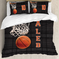 Close-up detail of textured basketball and orange hoop rim graphics on athletic sports bedding