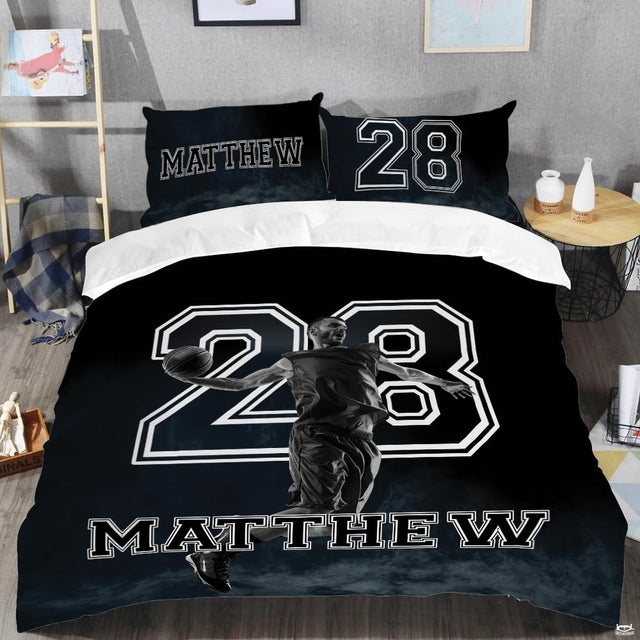 Close-up perspective of sports bedding detailing black and white athlete photo, basketball, and smoke fog