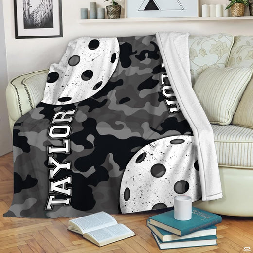 Camo pickleball court throw blanket featuring perforated white pickleballs on urban grayscale camouflage background