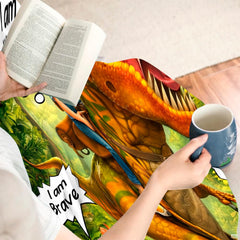 Bedroom setting featuring the vibrant dinosaur illustration with coordinating leafy accessories.