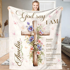 Floral wooden cross scripture throw blanket held open by woman
