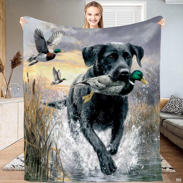 Scenic waterfowl hunting motif featuring a black retriever carrying a mallard drake across a glowing sunrise wetland.