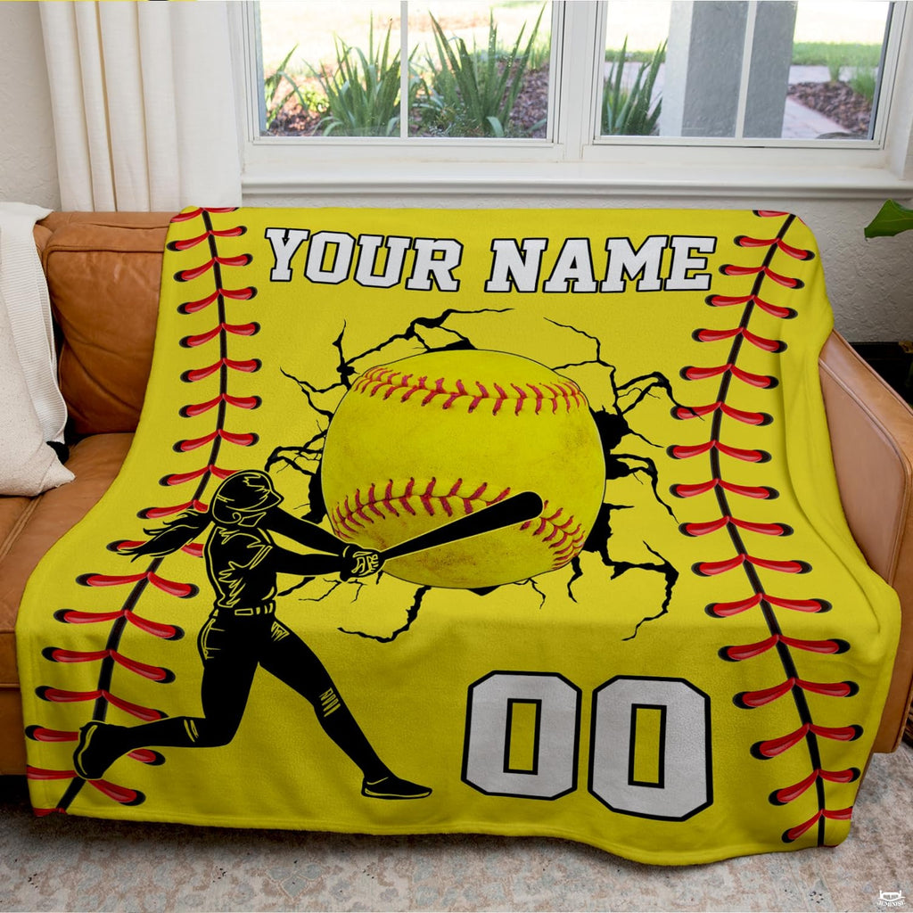 Living room staging displaying softball batter throw blanket draped across a modern couch.