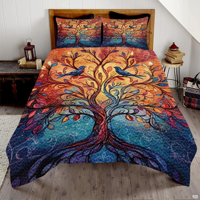 Stained glass Tree of Life bedding displaying colorful mosaic tree and perched bluebirds over amber and blue background