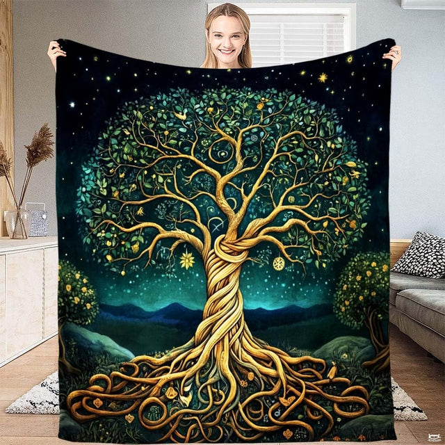 Model holding throw blanket featuring braided golden tree of life and emerald foliage under starry sky