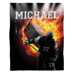 Graphic layout of ice hockey design with flaming puck and player holding stick on black background.