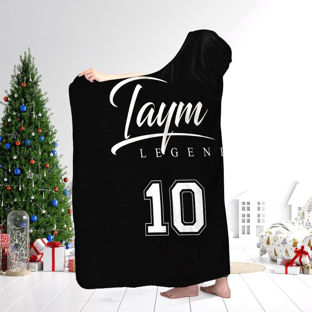 Soccer athletic blanket worn over shoulders showcasing sports jersey aesthetic in a holiday living room.