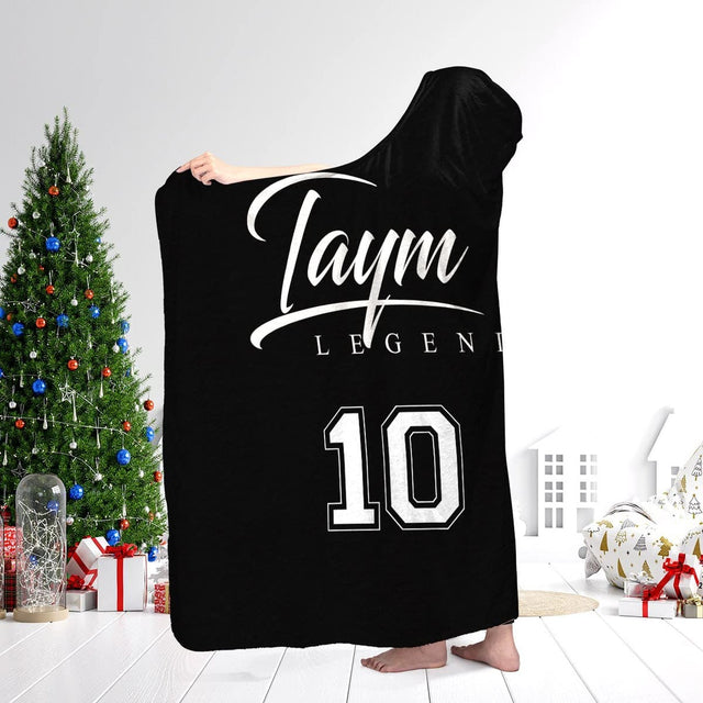 Soccer athletic blanket worn over shoulders showcasing sports jersey aesthetic in a holiday living room.