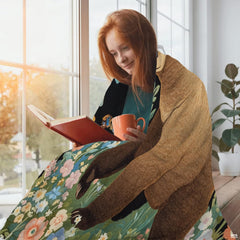 Floral garden bear throw blanket draped across living room sofa
