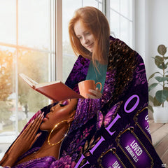 Artistic portrait with voluminous curls and radiant blossom accents centered on purple bedroom visual styling.