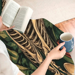 Model holding the gothic skeleton couple throw blanket showing romantic macabre composition.
