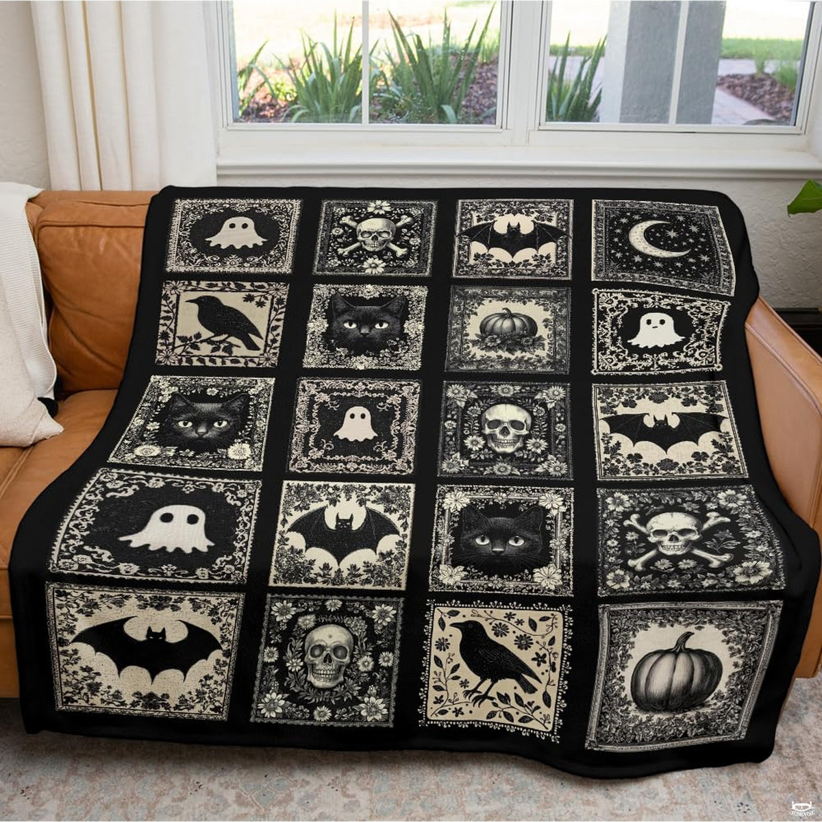 Living room sofa displaying the gothic cameo tile throw blanket draped across furniture.