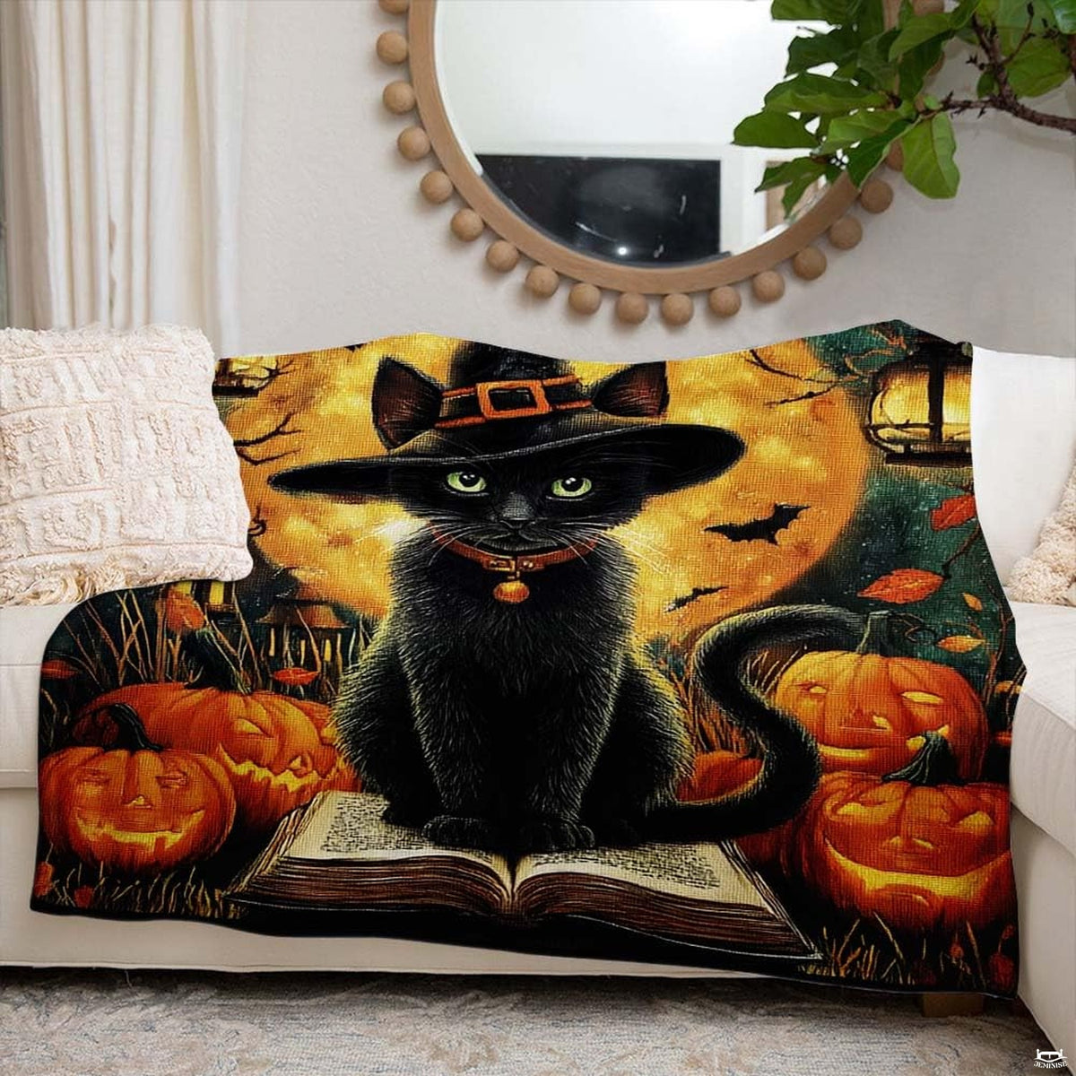 Halloween black cat blanket draped across a modern living room couch alongside autumn holiday accents