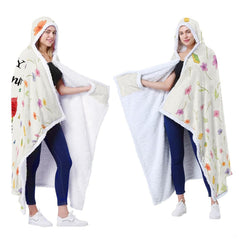 Folded sympathy blanket highlighting delicate blue blossoms and feathered angel wings.