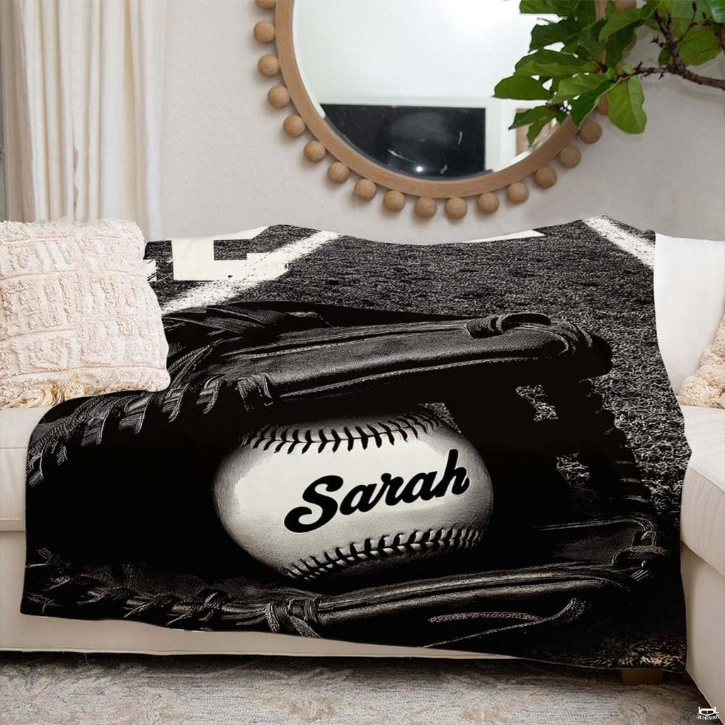 Monochrome baseball artwork blanket styled across modern couch sofa