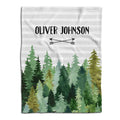 Flat lay view showing watercolor evergreen pine forest and crossed arrows beneath horizontal gray stripes.