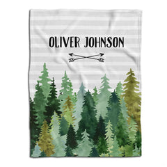 Flat lay view showing watercolor evergreen pine forest and crossed arrows beneath horizontal gray stripes.
