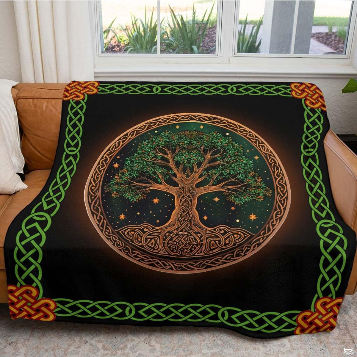 Atmospheric living room couch setting featuring green Celtic Tree of Life border throw blanket