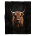 Dramatic portrait of Scottish Highland cow with curved horns emerging from black background, view 1.