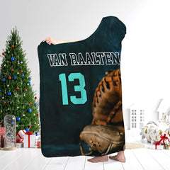 Person wearing the baseball art textile while standing next to a decorated holiday evergreen tree.