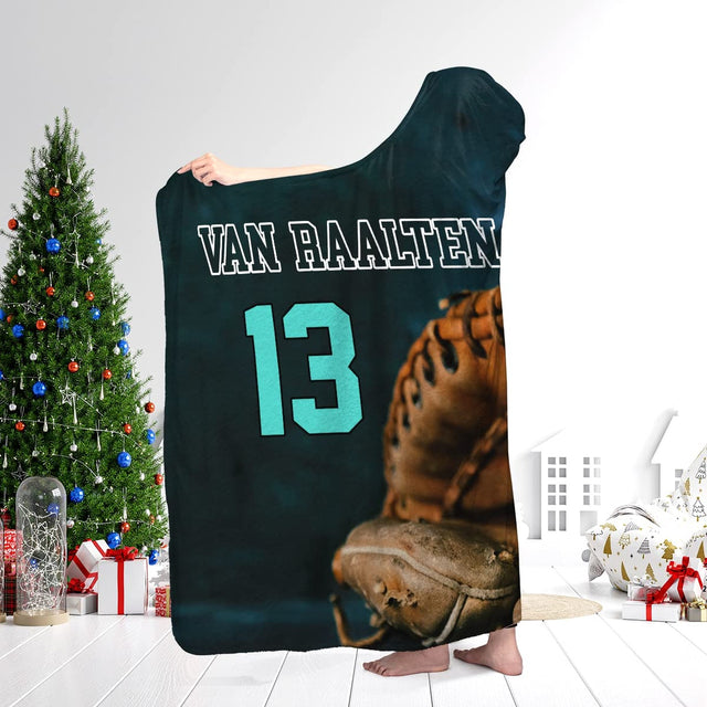 Person wearing the baseball art textile while standing next to a decorated holiday evergreen tree.