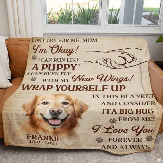 Golden retriever memorial throw blanket draped across a living room sofa