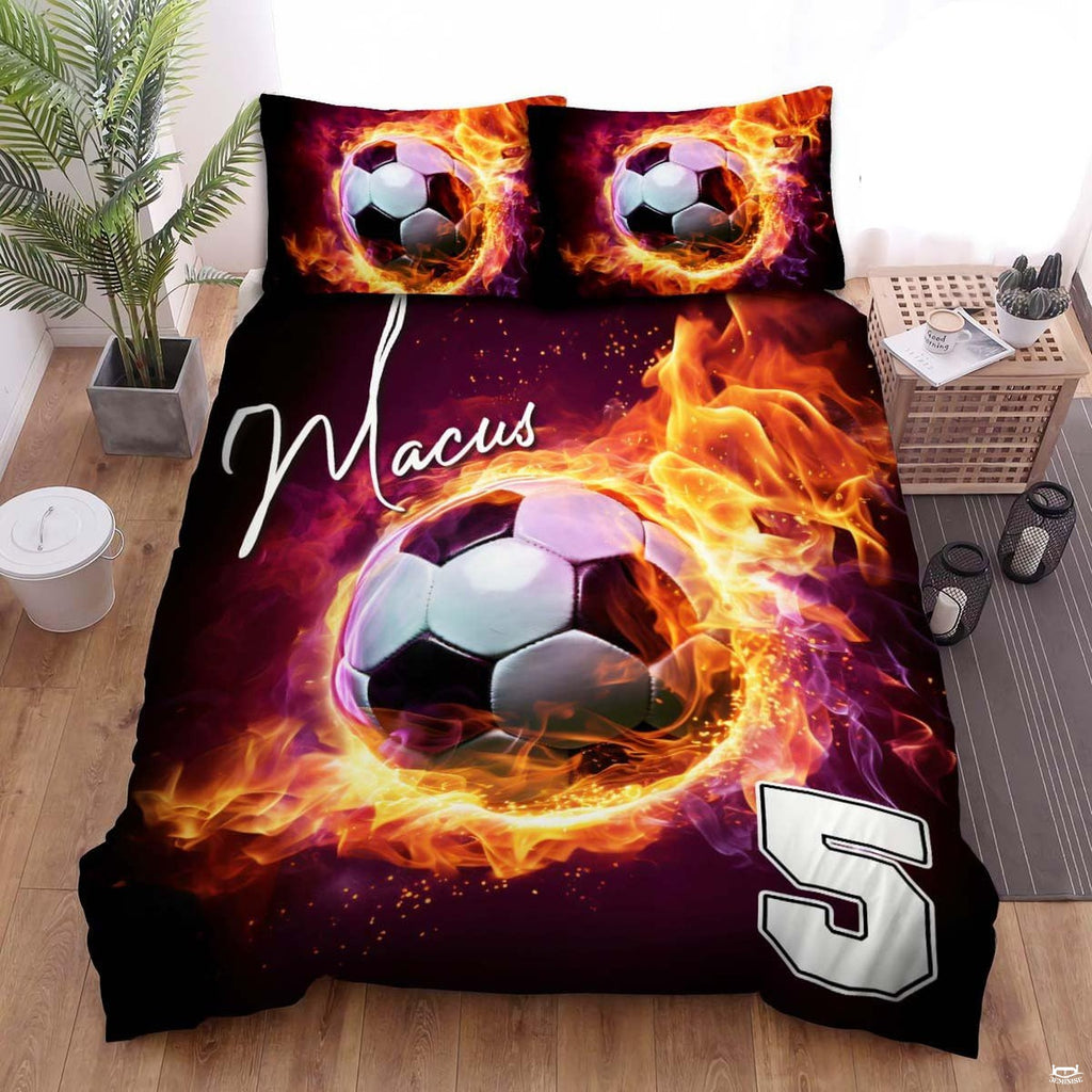 Crimson magenta and gold soccer sports bedding featuring a soccer ball graphic with colorful streaks on a bed