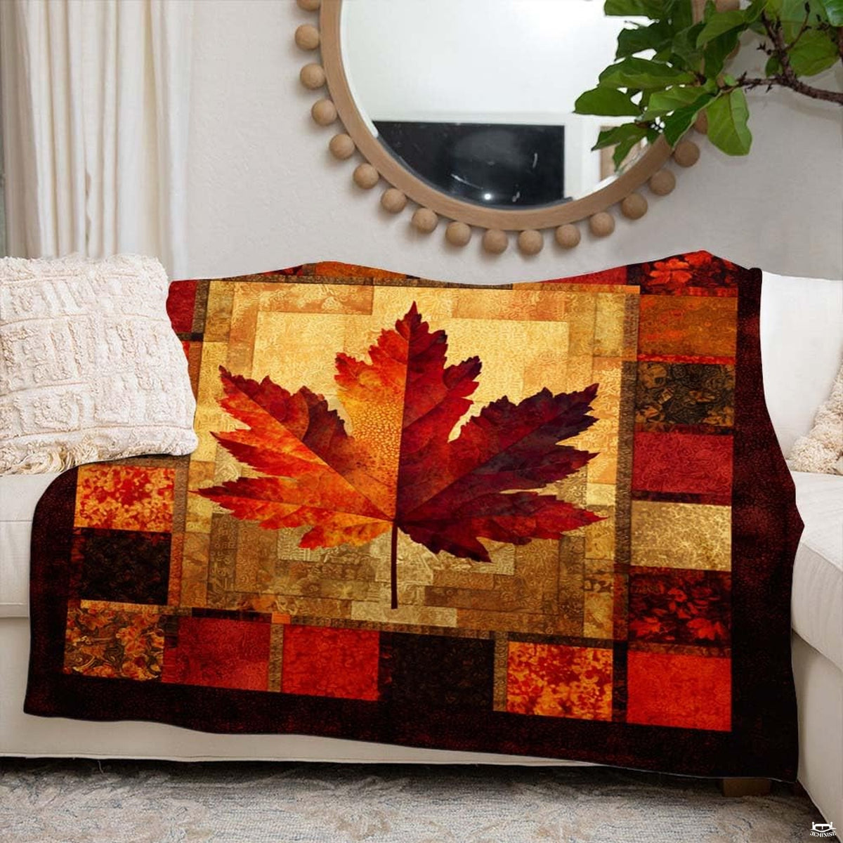 Autumn maple leaf blanket styled across an armchair in a rustic wood-accented living room