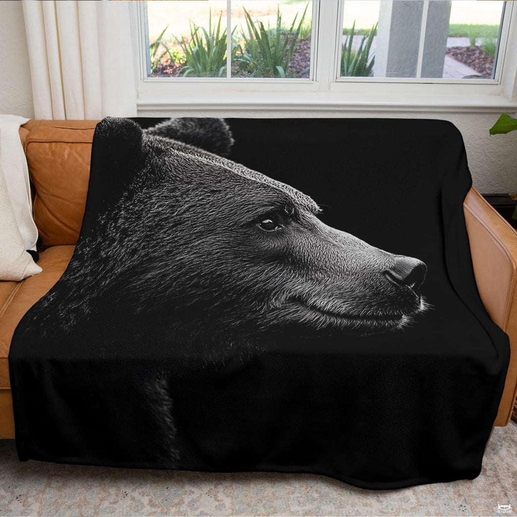 Close up of monochrome bear throw blanket highlighting silvery fur textures and detailed bear profile
