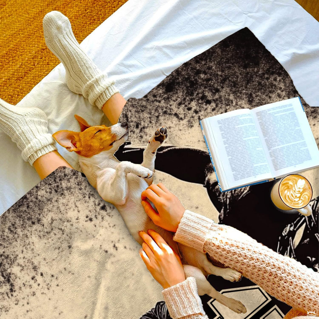 Throw blanket laid across lap while relaxing with a sleeping puppy and warm coffee mug.