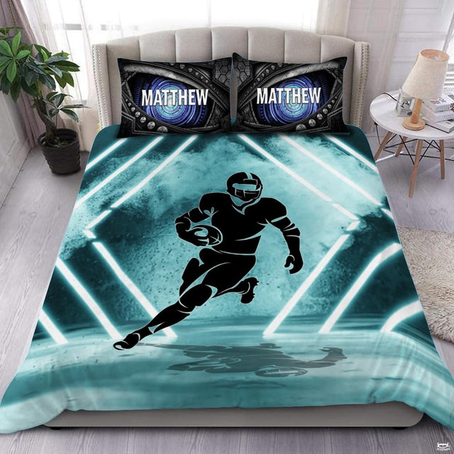 Seafoam teal football sports bedding featuring a textured football graphic and aqua yard lines on a bed